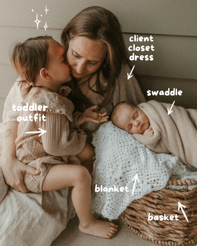 Toddler kissing mother while newborn sleeps in basket wrapped in swaddle