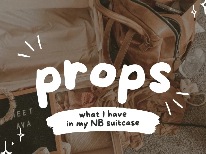 Flat lay of open suitcase filled with newborn photography props and a leather bag