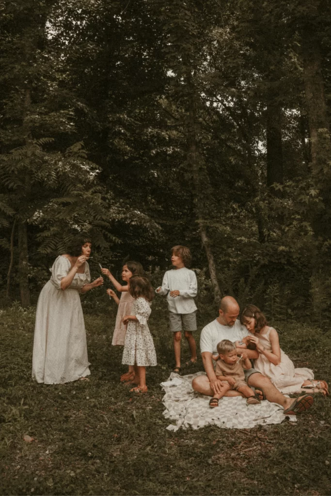 Large family enjoying a summer day in the forest clearing